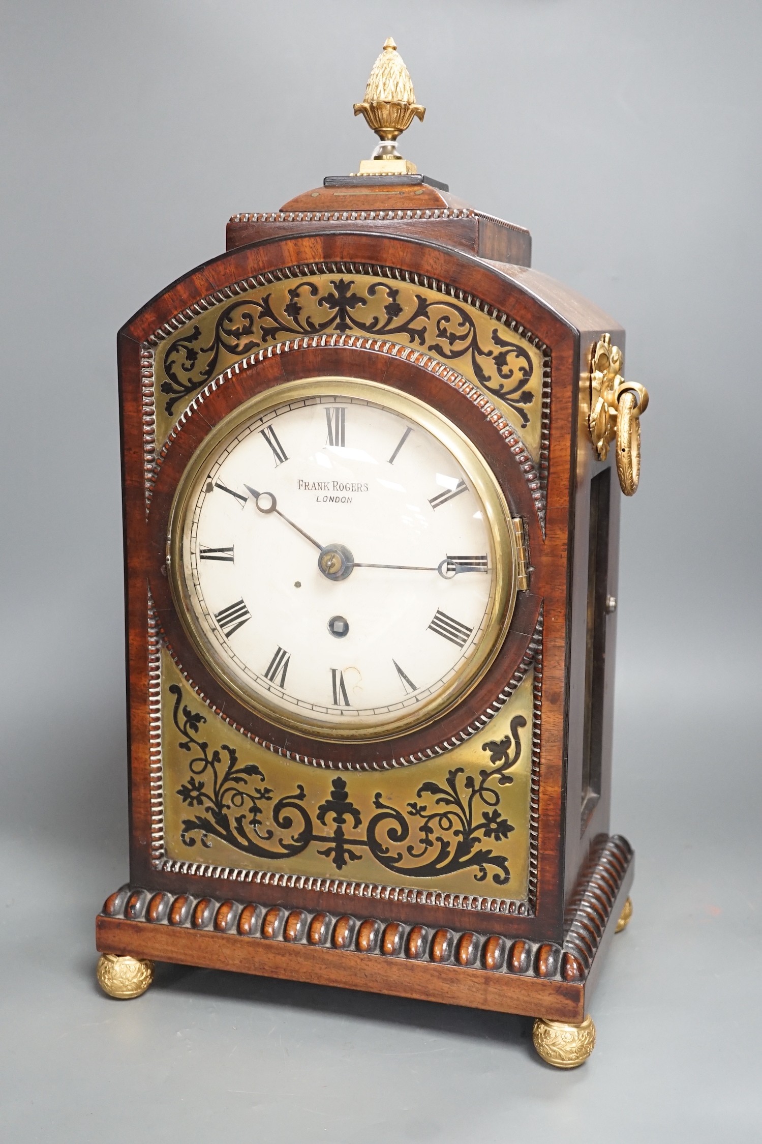 A Regency cut brass inlaid mahogany bracket timepiece by Frank Rogers, 46cm tall